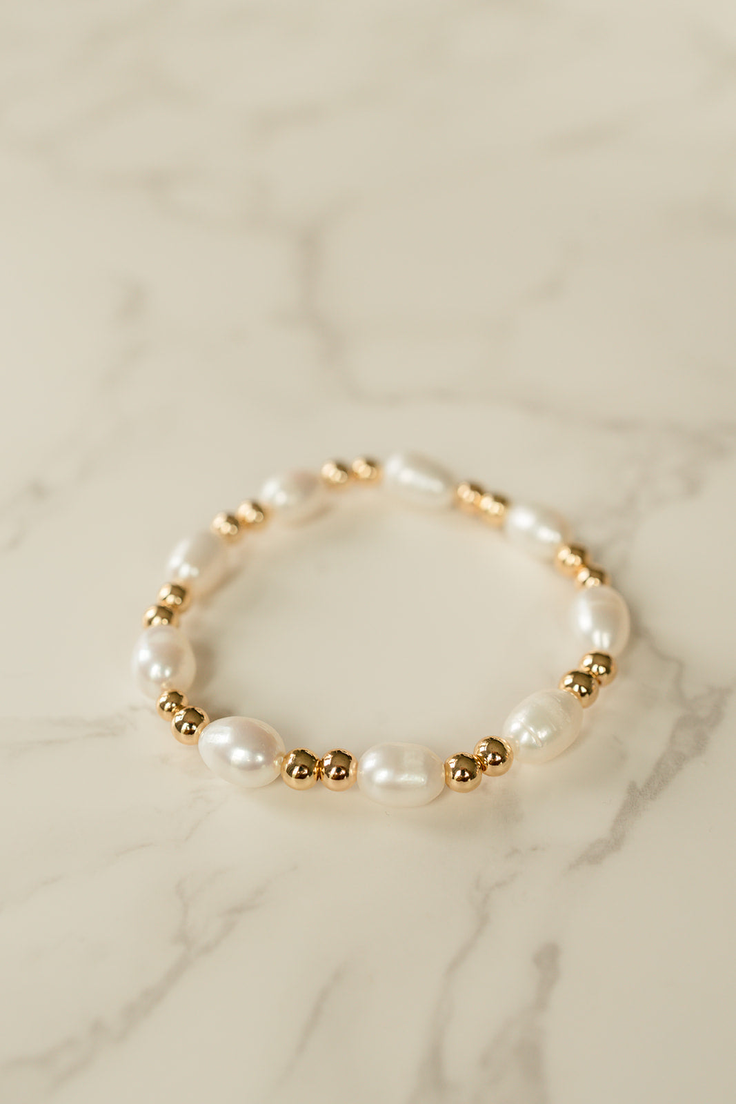 Luxe Pearl Bracelet showcasing lustrous freshwater pearls and gold beads