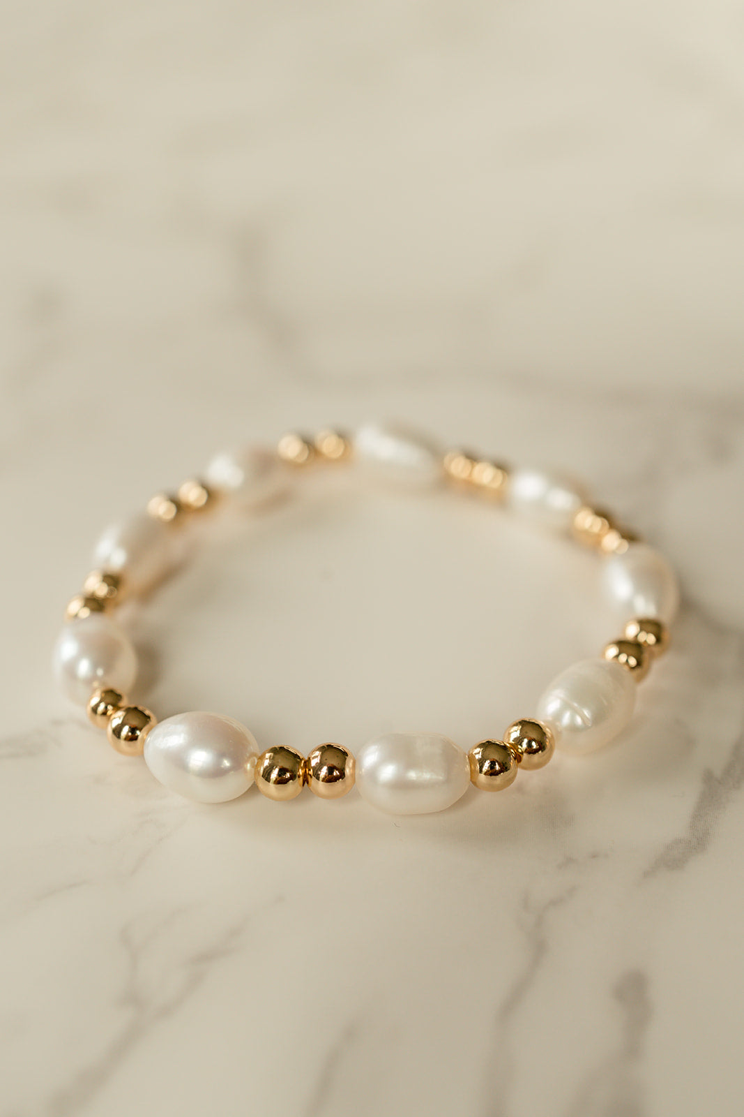 Close-up of the delicate freshwater pearls and gold-overlaid brass beads