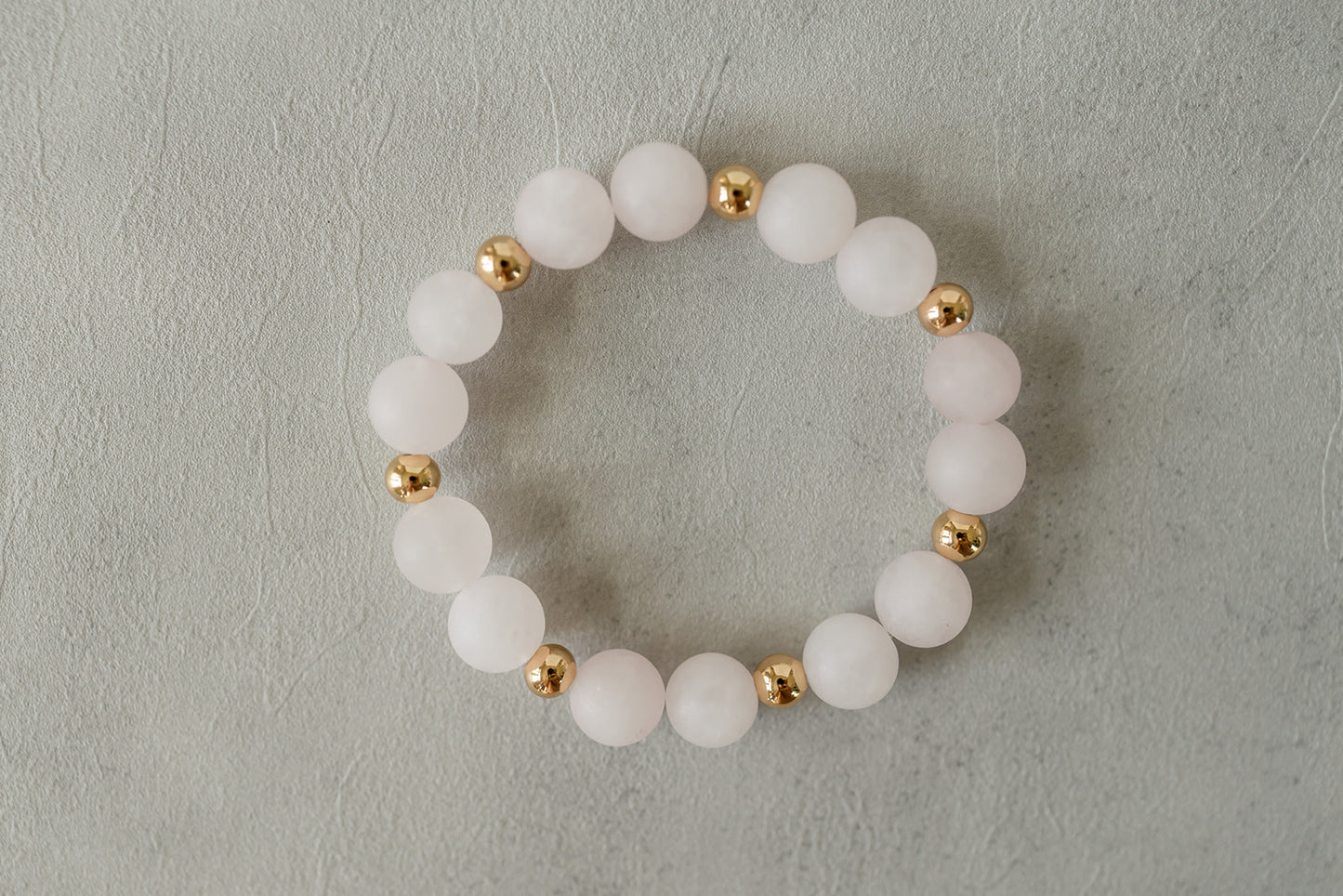 Close-up of the delicate rose quartz beads of the Quartz Blush Bracelet