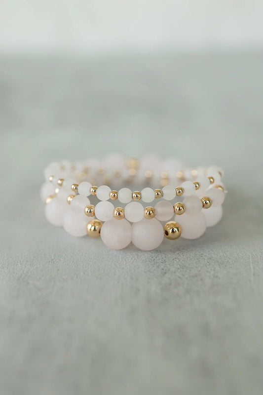 a stack of quartz blush bracelets