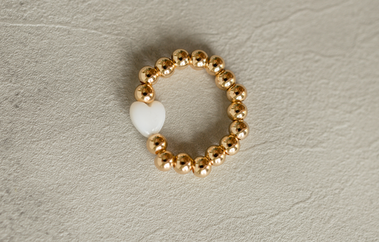 Heart of Gold Ring featuring a white heart bead and gold overlaid brass beads